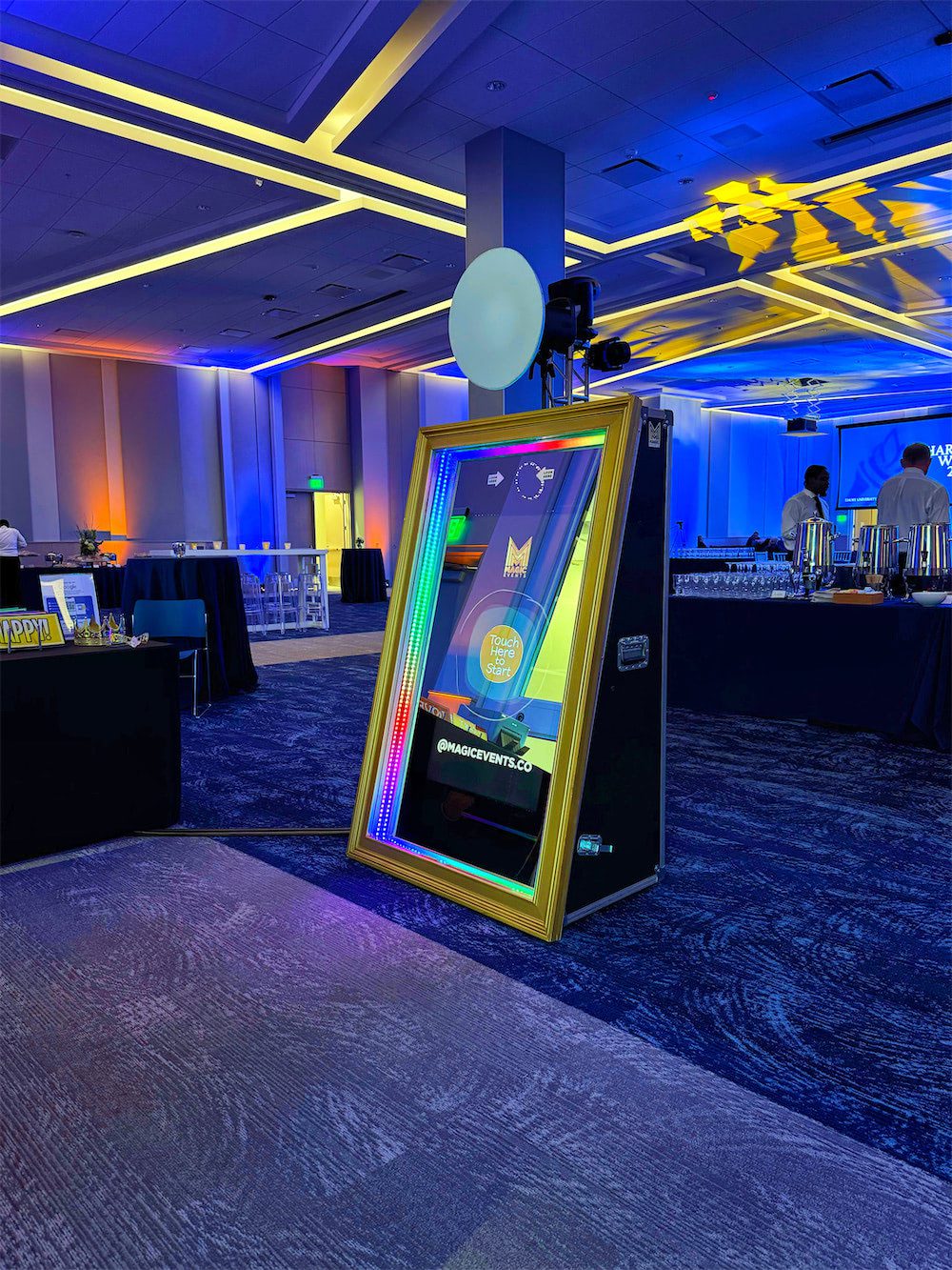 Magic Mirror Photo Booth setup at Emory Charter Week 2025, featuring a gold-framed interactive mirror with LED lighting, a professional camera setup, and a spacious event venue in Atlanta.